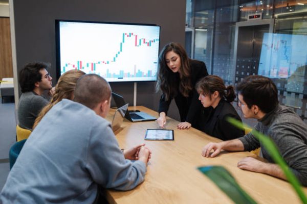 Young business people having stock trading and investing course